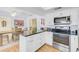 Eat-in kitchen with island, stainless steel appliances, and white cabinets at 308 Matisse E Cir, Nokomis, FL 34275