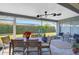 Relaxing screened patio with wooden dining set and ceiling fan at 308 Matisse E Cir, Nokomis, FL 34275