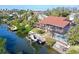 Aerial view of the home with boat dock, pool, lanai, and waterfront canal access at 3131 Bayou Sound, Longboat Key, FL 34228