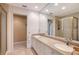 Bright bathroom featuring double sinks, large mirror, and a separate shower and toilet room at 3131 Bayou Sound, Longboat Key, FL 34228