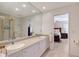 Bright bathroom featuring double sinks, large mirror, and access to the primary bedroom at 3131 Bayou Sound, Longboat Key, FL 34228