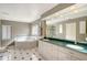 Bathroom featuring a large mirror, white vanity with green countertops, and a soaking tub at 3131 Bayou Sound, Longboat Key, FL 34228
