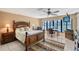 Large bedroom with a ceiling fan, a view to the pool, and a king-size bed at 3131 Bayou Sound, Longboat Key, FL 34228
