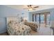 Comfortable guest bedroom with two beds, ceiling fan, and sliding glass doors to an outdoor deck at 3131 Bayou Sound, Longboat Key, FL 34228