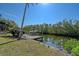 Private boat dock with lift on the canal, surrounded by lush tropical foliage at 3131 Bayou Sound, Longboat Key, FL 34228