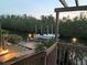 Evening view of the private dock featuring a boat lift, with landscape lighting at 3131 Bayou Sound, Longboat Key, FL 34228