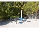 Community grilling area with multiple grills and a table, surrounded by lush tropical landscaping at 3131 Bayou Sound, Longboat Key, FL 34228