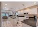Spacious kitchen with breakfast bar, black countertops, and views to the connected living area at 3131 Bayou Sound, Longboat Key, FL 34228