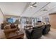 Open-concept living room with vaulted ceilings, fireplace, neutral tile floors, and scenic views through sliding glass doors at 3131 Bayou Sound, Longboat Key, FL 34228