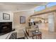 Open concept living room with fireplace, clerestory windows, vaulted ceilings, and kitchen access at 3131 Bayou Sound, Longboat Key, FL 34228