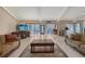 Comfortable living area with tile floors, sliding glass doors, ample seating, and entertainment center at 3131 Bayou Sound, Longboat Key, FL 34228