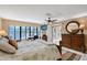Bright main bedroom with ceiling fan, desk, sliders to lanai, and ensuite bathroom at 3131 Bayou Sound, Longboat Key, FL 34228