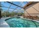 Relax in this private screened-in pool area with a hot tub and lush greenery at 3131 Bayou Sound, Longboat Key, FL 34228