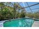 A screened-in pool offers a serene retreat surrounded by tropical landscaping and clear blue water at 3131 Bayou Sound, Longboat Key, FL 34228