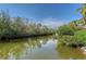 Scenic waterfront view showcasing lush mangroves reflecting in the tranquil canal at 3131 Bayou Sound, Longboat Key, FL 34228