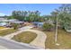 Aerial view of a single story home with a large driveway and mature trees at 3419 27Th Pkwy, Sarasota, FL 34235