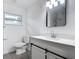 Modern bathroom with white vanity, gray tile floors, and black accents at 3419 27Th Pkwy, Sarasota, FL 34235