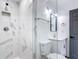 Clean bathroom with a walk-in shower, marble tile and white vanity at 3419 27Th Pkwy, Sarasota, FL 34235