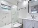 Modern bathroom with a glass shower, marble tile and white vanity at 3419 27Th Pkwy, Sarasota, FL 34235