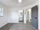 Well-lit bedroom with an en-suite bathroom and grey tile floors at 3419 27Th Pkwy, Sarasota, FL 34235