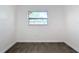 Simple bedroom with gray tile floors and a window at 3419 27Th Pkwy, Sarasota, FL 34235