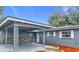Exterior view of a renovated home with a carport and stone accents at 3419 27Th Pkwy, Sarasota, FL 34235