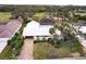 White-roofed house with pool and lush landscaping, offering a desirable location at 3746 Torrey Pines Blvd, Sarasota, FL 34238