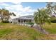 Landscaped backyard with screened pool and patio at 3746 Torrey Pines Blvd, Sarasota, FL 34238