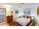 Cozy bedroom with a queen-size bed and wood floors at 3746 Torrey Pines Blvd, Sarasota, FL 34238