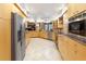 Modern kitchen with light wood cabinets, stainless steel appliances, and granite counters at 3746 Torrey Pines Blvd, Sarasota, FL 34238
