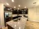 Kitchen island with granite countertop and stainless steel sink at 4035 Wayfarer Way, Palmetto, FL 34221