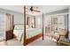 Bedroom with a four-poster bed and sliding glass doors at 404 Cerromar N Cir # 108, Venice, FL 34293