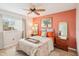 Comfortable bedroom with ceiling fan and accent wall at 404 Cerromar N Cir # 108, Venice, FL 34293
