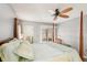 Bedroom with a four-poster bed and sliding glass doors at 404 Cerromar N Cir # 108, Venice, FL 34293