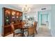 Dining room with a round table and view into the kitchen at 404 Cerromar N Cir # 108, Venice, FL 34293