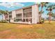 Building exterior, showcasing landscaping and balconies at 404 Cerromar N Cir # 108, Venice, FL 34293