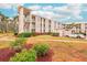 Building exterior with landscaping and parking area at 404 Cerromar N Cir # 108, Venice, FL 34293
