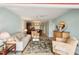 Bright living room with seating area and view to dining area at 404 Cerromar N Cir # 108, Venice, FL 34293
