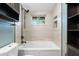 Updated bathroom with a soaking tub, tile surround, and modern fixtures at 4042 Radnor Pl, Sarasota, FL 34233