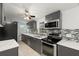 Modern kitchen with gray cabinets, quartz countertops and stainless steel appliances at 4042 Radnor Pl, Sarasota, FL 34233