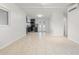 Open concept kitchen and living area with tile floors and neutral walls at 4042 Radnor Pl, Sarasota, FL 34233