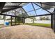 Spacious screened patio with paver stones and backyard view at 4042 Radnor Pl, Sarasota, FL 34233