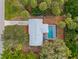 Aerial view showing home, pool, and surrounding trees at 4363 Melis St, Port Charlotte, FL 33948