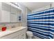Clean bathroom, white vanity, and blue shower curtain at 4363 Melis St, Port Charlotte, FL 33948