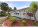 Light green house exterior with well-manicured landscaping at 4363 Melis St, Port Charlotte, FL 33948