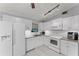 White kitchen with granite countertops and stainless steel appliances at 4363 Melis St, Port Charlotte, FL 33948