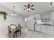Bright kitchen with white cabinets, granite counters, and a dining area at 4363 Melis St, Port Charlotte, FL 33948