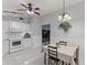 Bright kitchen with white cabinets, granite counters and view to living room at 4363 Melis St, Port Charlotte, FL 33948