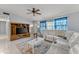 Living room with white sectional sofa and entertainment center at 4363 Melis St, Port Charlotte, FL 33948