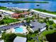 Aerial view of waterfront community, featuring a pool and individual condo building at 4799 Independence Dr, Bradenton, FL 34210